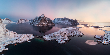 Panorama aerial view of scandinavian archipelago with mountain range on arctic ocean at sunset, Reine, Lofoten, Norwayの写真素材