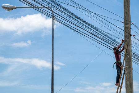 Electrician worker repairing power cable on highの写真素材