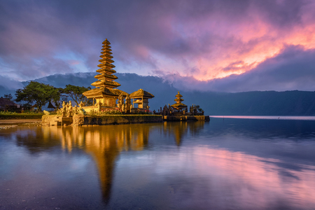 Ancient Pura Ulun Danu Bratan temple reflection with colorful sky at sunrise. Bali, Indonesiaの写真素材