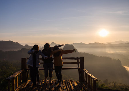 Mae Hong Son - Dec 16 2016 : Tourists women group standing poses on wooden terrace famous in baan...