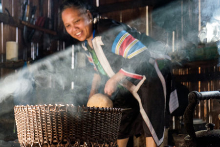 Mae Hong Son,Thailand - Dec 25 2016 : Tribe old woman picking pumpkin in wooden basket in kitchenのeditorial素材