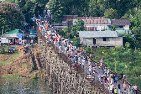 Kanchanaburi, Thailand - Aug 13 2017 : Tourists crowd travel on wooden mon bridge in holidayのeditorial素材