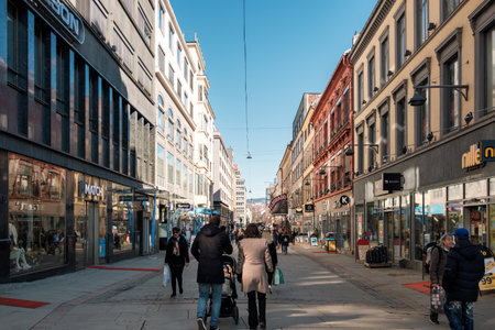 Oslo, Norway - Mar 27 2018 : Norwegian people walking with shopping in historic alley downtownのeditorial素材