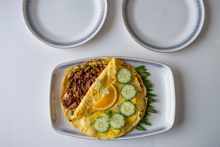 Food recipe of Omelet fried with pork chops on dining tableの写真素材
