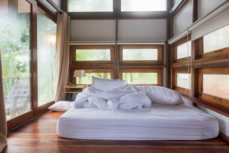 Nan, Thailand - Aug 05 2018 : Interior cozy bedroom after waking up in wooden house at morningのeditorial素材