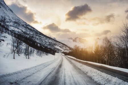 Dirty snow road with sunlight in valley at countrysideの写真素材