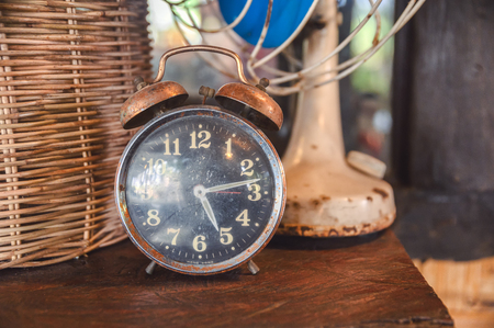 Retro alarm clock decorative on hardwood tableの写真素材