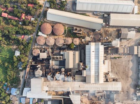 Industry factory manufacturing with emission smoke from chimneys into skyの写真素材