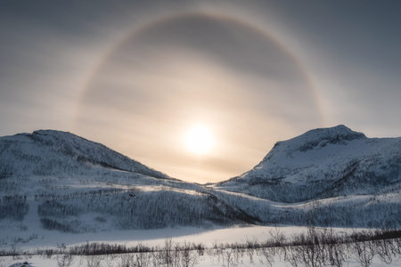Snow mountain range with sun halo in winter at morning