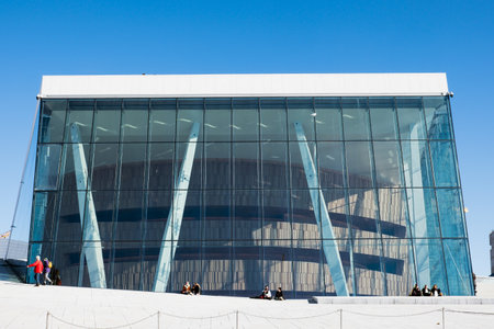 Oslo, Norway - Mar 27 2018 : Architecture building with blue glass and tourists traveling and relaxation at Opera House landmarkのeditorial素材