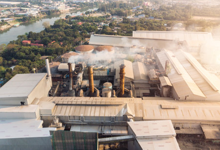 Industry factory manufacturing with emission smoke from chimneys into skyのeditorial素材