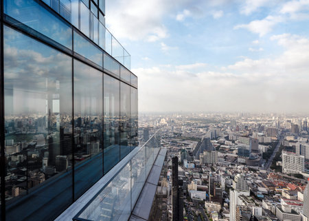 Modern glass building with crowded downtown at bangkok city with blue sky