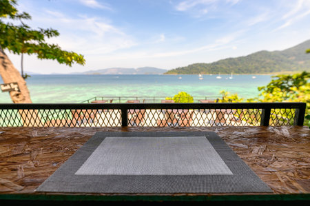 Napery on wooden counter with sea view in restaurantの写真素材