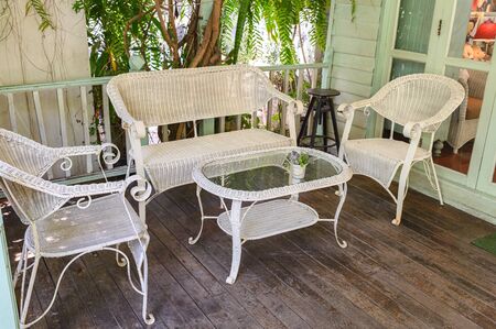 Antique weaving chairs with table on wood patio in living roomの写真素材