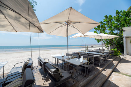 Sea view with dining table and umbrella in exotic restaurant on coastline
