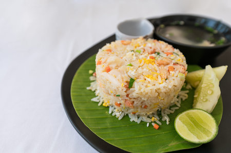 Crab meat fried rice of thai food with fry egg, vegetable and soup on the table