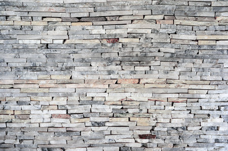 Horizontal stacked granite stone brick wall, pattern and background