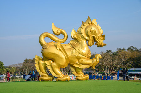 Chiang Rai, Thailand - Feb 13 2019 : Golden big statue singha icon on green hill at singha parkのeditorial素材