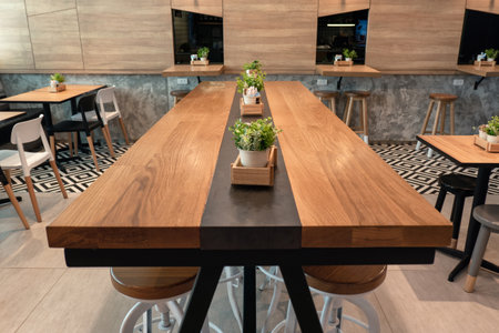 Bangkok, Thailand - Dec 14 2018 : Wooden large table with chairs and plant decoration in cafeのeditorial素材
