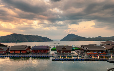 Kanchanaburi, Thailand - Apr 06 2019 : Tourists relaxing on wooden raft resort floating on Srinakarin dam in evening at Ananta river hills, Kanchanaburiのeditorial素材