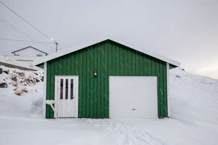 Wooden green house with snow covered in snowing on winter at scandinaviaの写真素材