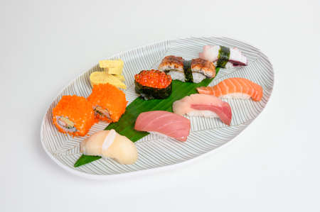 Japanese roll salmon cheese smoked with vegetable filled set on ceramic dishの写真素材