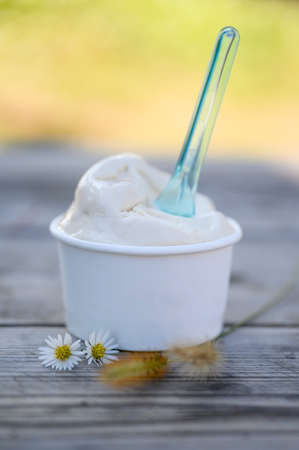 Rear of woman wearing winter coat and hat standing on rocky pier with wave hitting in the sunset at Jumunjin Beach, Gangwon-Do, South Koreaの写真素材