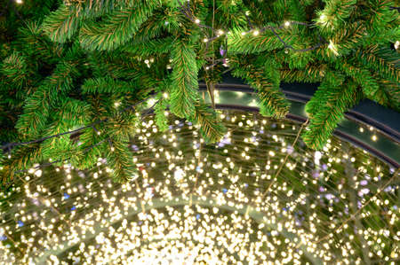 Glittering string lights with pine leaf decoration on arch at Christmas Eveの写真素材