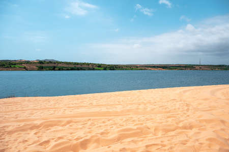 White sand dune with blue sky in desert on sunnyの写真素材