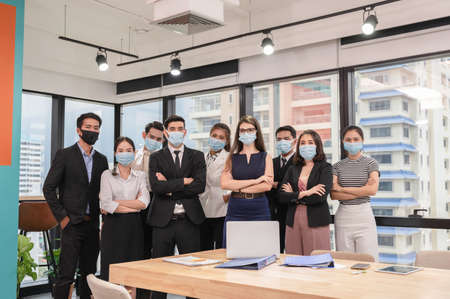 Multiethnic confident business people crossed arms in modern office at business districtの写真素材