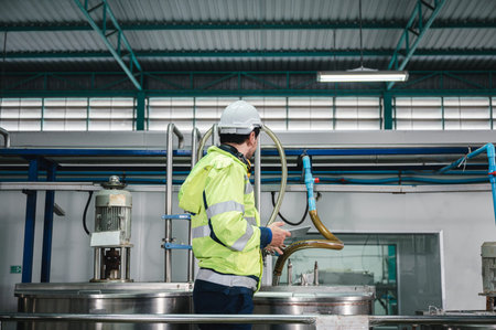 Caucasian technician engineer man in uniform with tablet checking and control boiler tanks and...