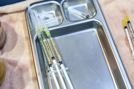 Syringe injection with liquid filler, collagen skin care rejuvenation or antivirus vaccine on tray...