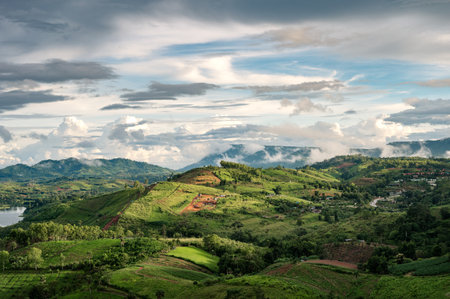 Landscape of rural agricultural hill with sunlight shine in rainy season at Khao Kho, Phetchabunの写真素材