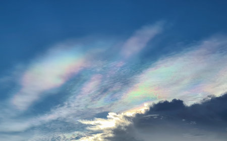 Natural phenomenon of rainbow cloud or iridescent cloud in blue sky