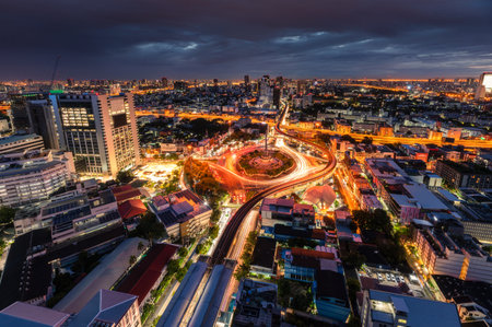 Cityscape of Victory Monument with car traffic on roundabout road in the morning at Bangkok, Thailandの写真素材