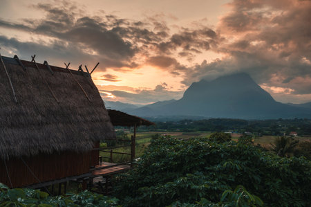 View of wooden hut and Doi Luang Chiang Dao mountain view in the sunset at Chiang Dao, Chiang Mai, Thailandの写真素材