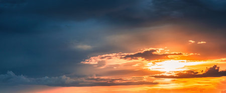 Beautiful golden sunset shining with clouds in the sky at eveningの写真素材
