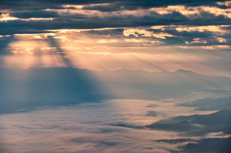 Beautiful dramatic sunrise shining on mountain with foggy in the valley at national park. Doi Dam, Wiang Haeng, Chiang Mai, Thailandの写真素材