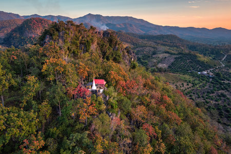 Aerial view of white pagoda on the mountain with colorful foliage in autumn forest at evening. Chiang Dao, Chiang Mai, Thailandの写真素材