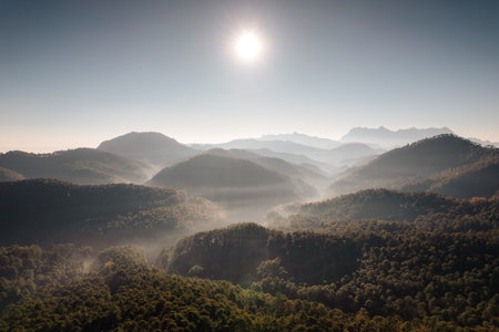 Aerial view of Doi Luang Chiang Dao with stacked mountain layer and foggy on sunny day in tropical...