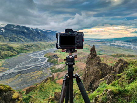 Mirrorless camera standing on tripod and taking photos at viewpoint of thorsmork valley in highlands of Icelandの写真素材