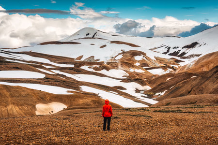 Successful hiker man standing at Kerlingarfjoll on geothermal area and volcano mountain in summer at Highlands of Icelandの写真素材
