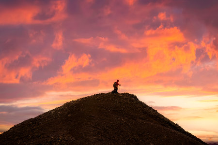 Group of hiker standing on top of volcanic mountain with colorful sky in the sunset among Icelandic Highlands in summer at Icelandの写真素材