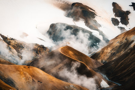 Beautiful scenery of tourist man walking on Kerlingarfjoll mountain in geothermal area on Hveradalir trail located in central icelandic highlands on summer at Icelandの写真素材