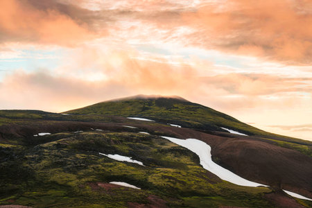 Icelandic volcano mountain with colorful sunset sky in wilderness at Icelandic Highlandsの写真素材
