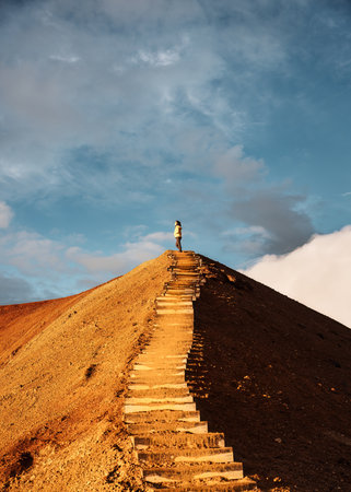 Female hiker standing on top of geothermal area among the volcanic mountain in summer at Kerlingjafjoll, Icelandの写真素材