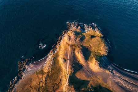Top view of road to lighthouse by coastline on summer in Atlantic peninsula at Icelandの写真素材