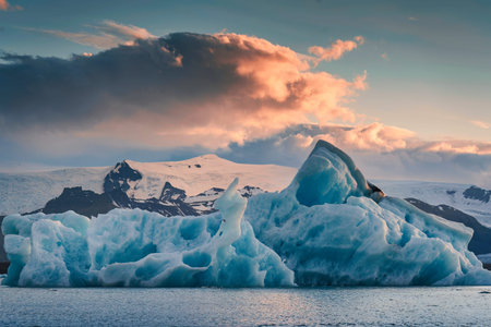Beautiful scenery of Jokulsarlon glacier lagoon with blue iceberg melting and sunset sky on summer...