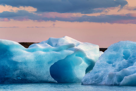 Beautiful scenery of Jokulsarlon glacier lagoon with blue iceberg melting and sunset sky on summer...