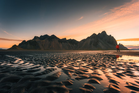 Stunning view of sunrise over Vestrahorn mountain with rippled black sand beach in summer on Stokksnes peninsula at Icelandの写真素材